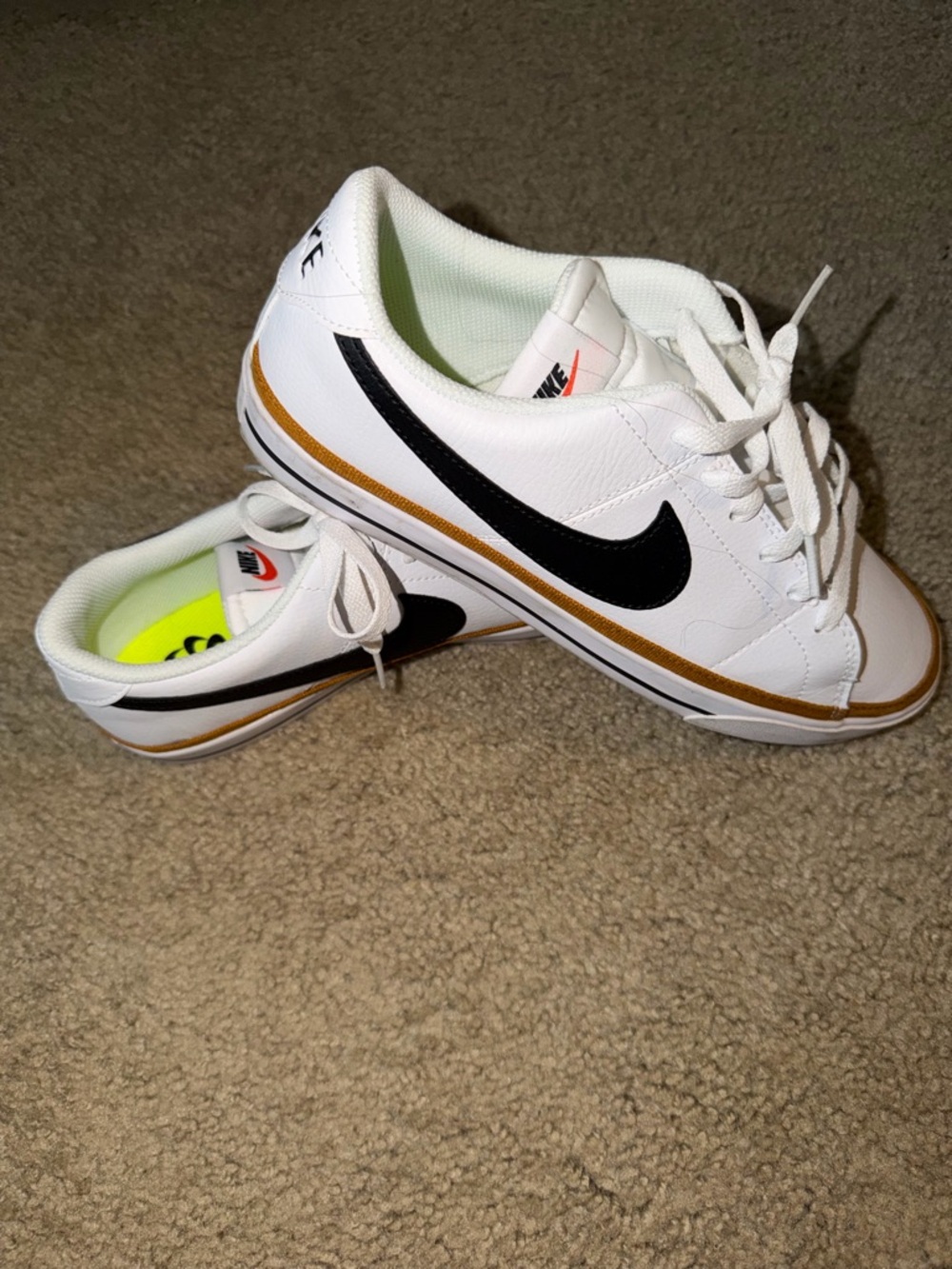 Nike White Sneakers with Black Swoosh and Gold Stripe